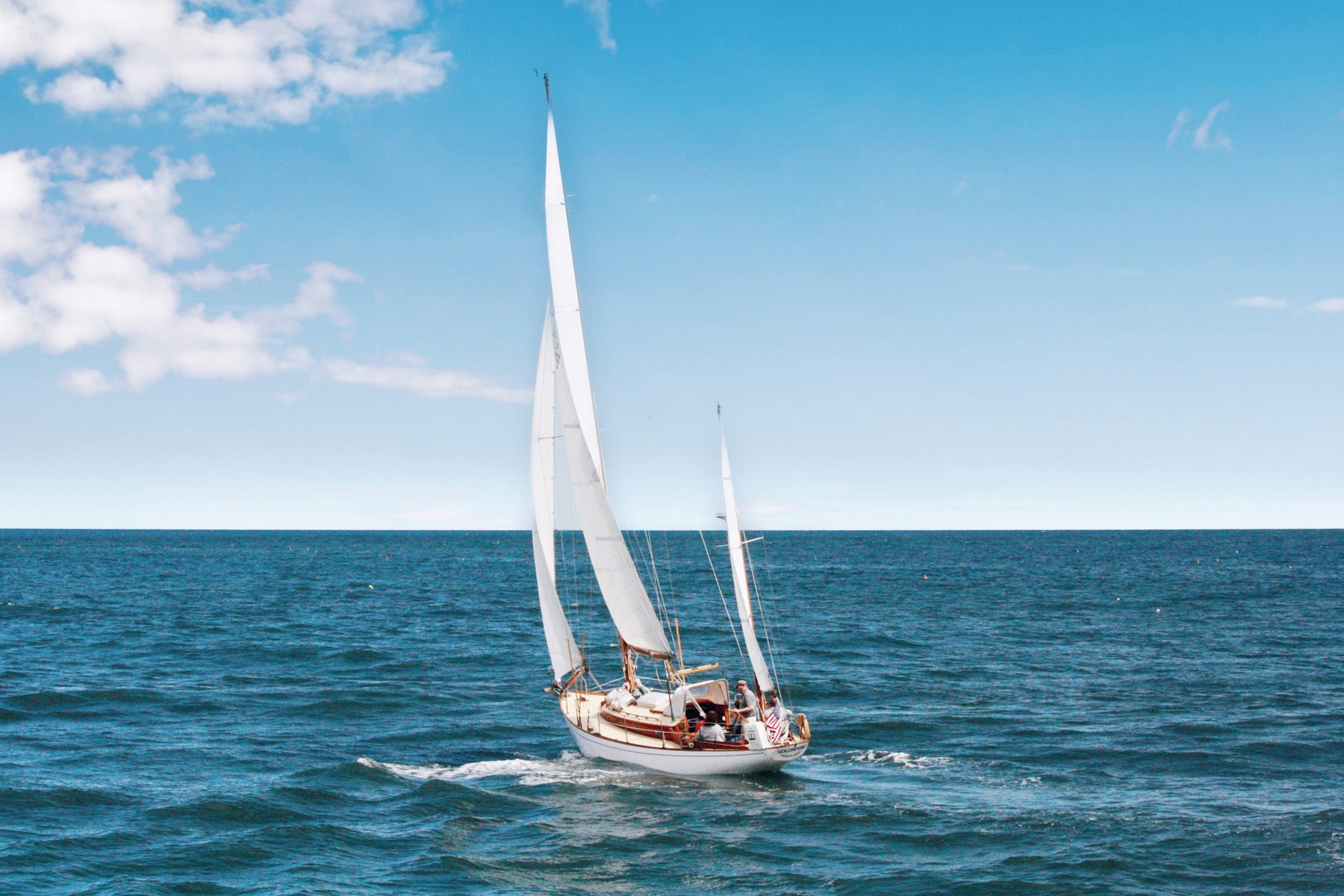 A modest sailboat underway on open water